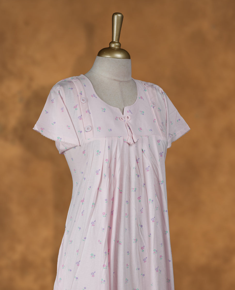 Baby pink colour Nstyle nighty with featuring a floral pattern, a Round neckline with slit cut, Short sleeve, and a full-length