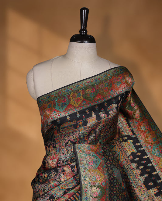 Black colour Pashmina silk saree densely woven with intricate multicolour floral and architectural motifs across the body, framed by an opulent arabesque border and grand storytelling pallu, paired with a matching black woven border blouse piece