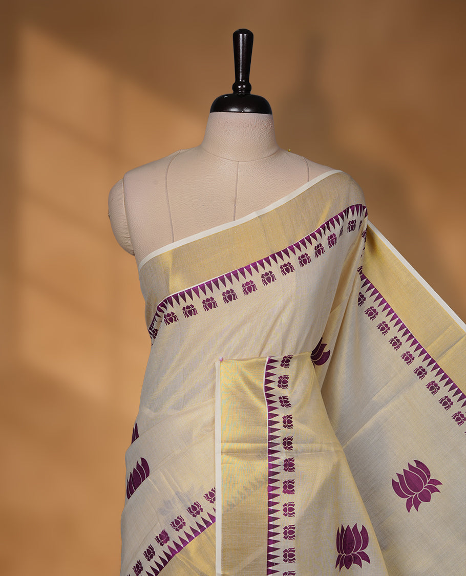 Off-white colour Tissue Kerala saree featuring elegant purple lotus motifs across the body, highlighted with a classic gold kasavu border and matching woven pallu, paired with a coordinating blouse.