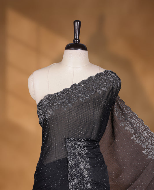 Black colour shimmer designer saree, featuring white scattered stone on body, stone work and heavy stone floral pattern on border and  pallu, Paired with matching blouse.