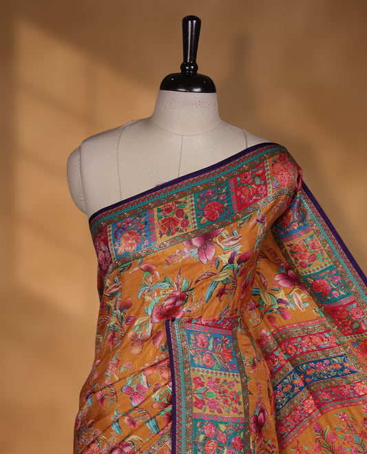 Mustard colour Pashmina silk saree richly woven with vibrant floral jaal across the body, framed by contrast pink and teal panelled zari borders and a grand patterned pallu, paired with a deep purple woven motif blouse piece.