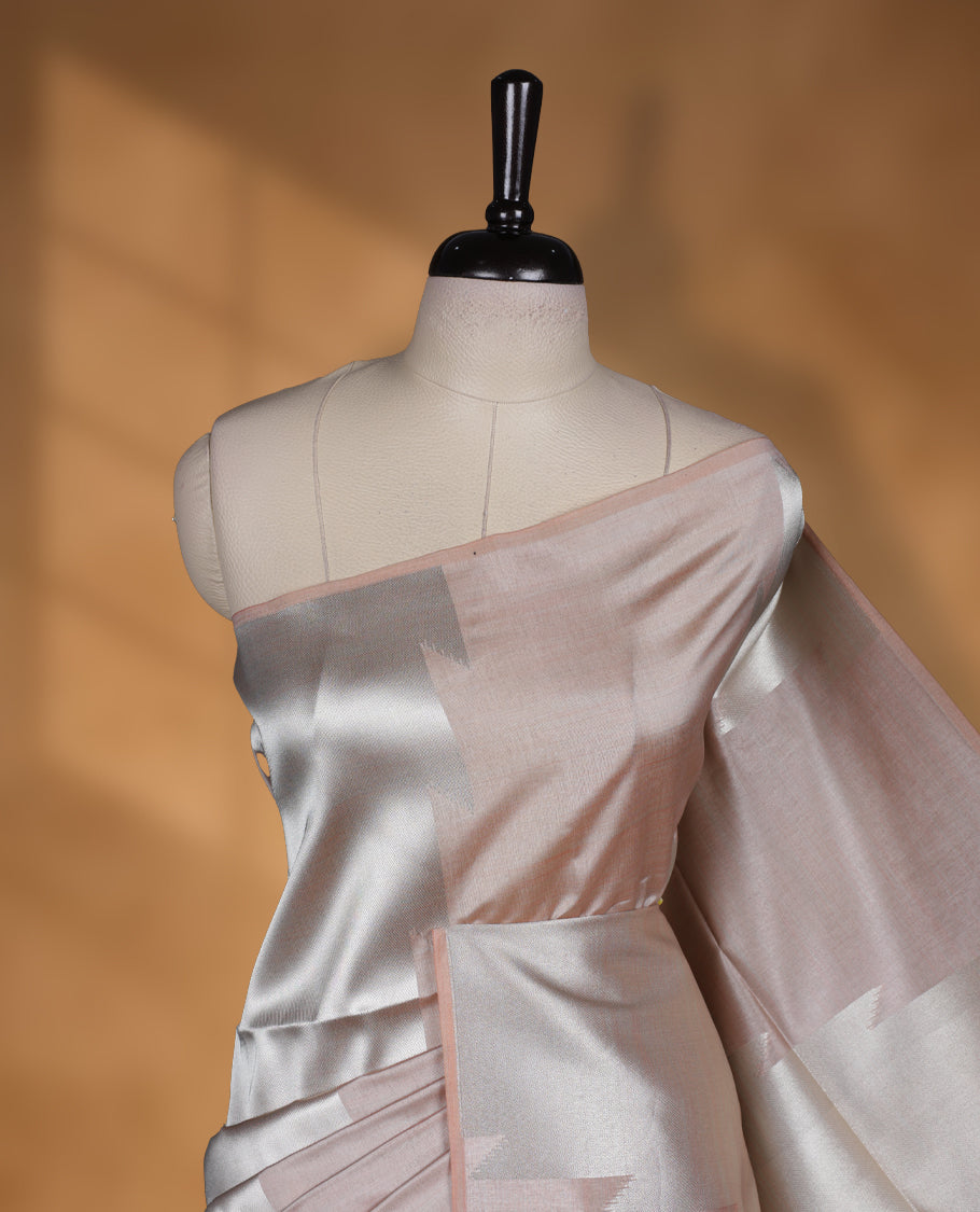 Cream and silver gold dual tone colour semi tussar saree featuring woven abstract geometric motifs on the body, complemented by a ikat inspired patterned brown pallu, paired with a matching blouse.