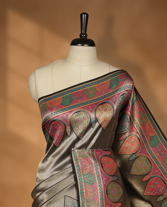 Antique bronze colour Pashmina silk saree featuring a sleek plain body, highlighted with an opulent multicolour paisley and floral panelled border and grand pallu, paired with a contrasting black woven jaal blouse piece.