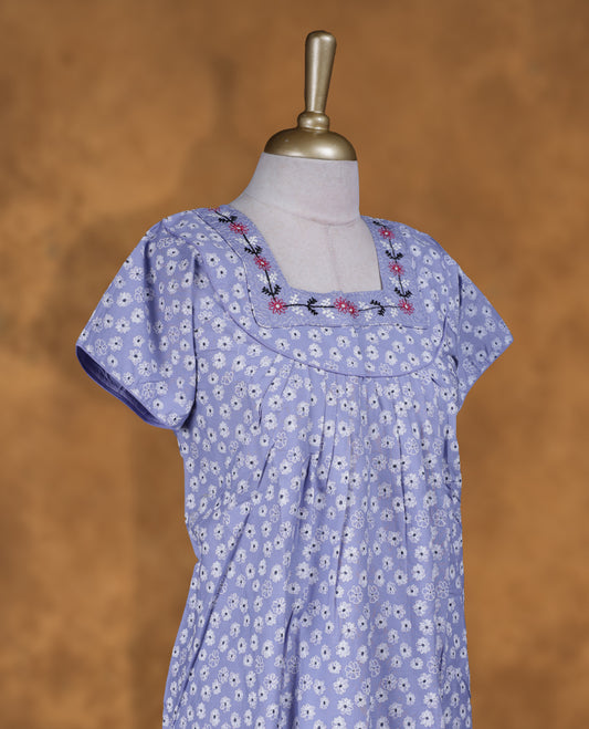 Light lavender colour NStyle nighty featuring White floral patterns, a Square neckline and thread pattern, short sleeves, and a full ankle-length design.