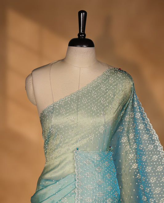 Light blue Colour Shimmer Designer Saree featuring Delicate White Stone Scattered Work on the Body, enhanced with Intricate Stone Detailing on the Border and Pallu, paired with a Matching Blouse.