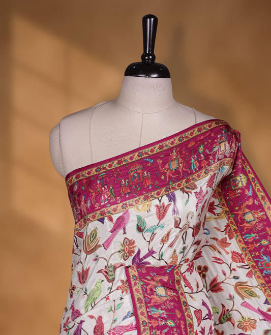 Ivory colour Pashmina silk saree intricately woven with multicolour birds and floral vines on the body, framed by a vibrant pink zari border and grand storytelling pallu with royal procession motifs, paired with a matching woven border blouse piece.