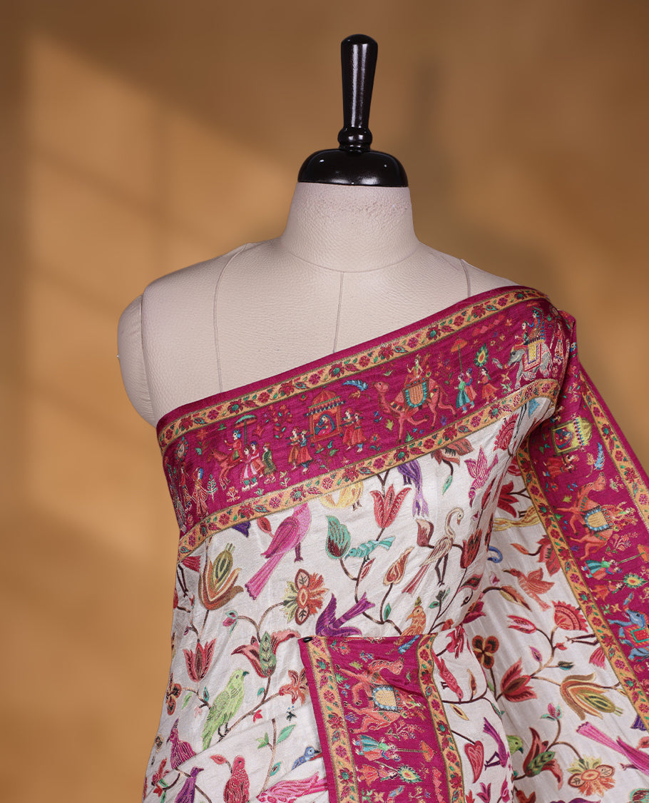 Ivory colour Pashmina silk saree intricately woven with multicolour birds and floral vines on the body, framed by a vibrant pink zari border and grand storytelling pallu with royal procession motifs, paired with a matching woven border blouse piece.