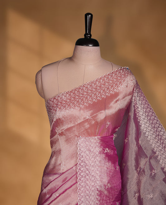 Pastel Mulberry colour net organza saree featuring white thread embroidery motifs on body and  thread detailing on the border and paired matching blouse.
