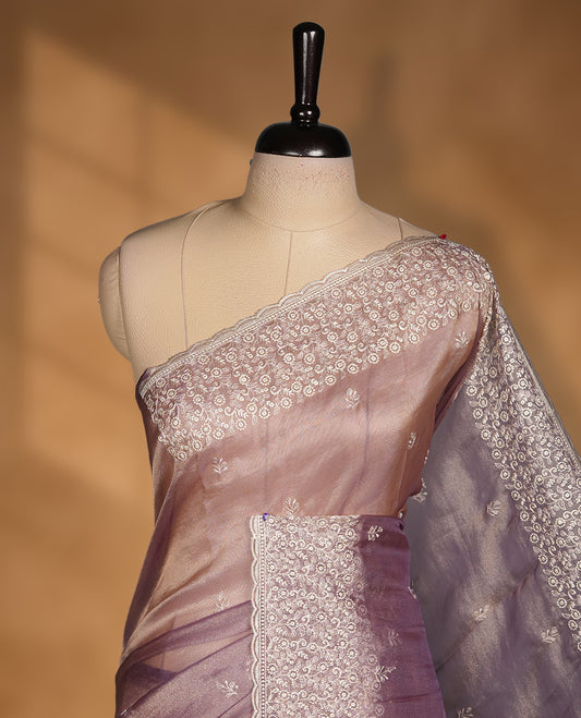 Pastel Purple colour net organza saree featuring white thread embroidery motifs on body and  thread detailing on the border and paired matching blouse.