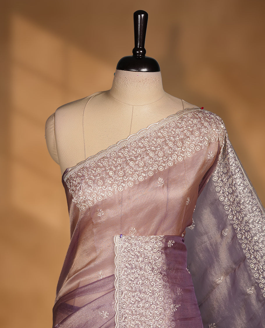 Pastel Purple colour net organza saree featuring white thread embroidery motifs on body and  thread detailing on the border and paired matching blouse.