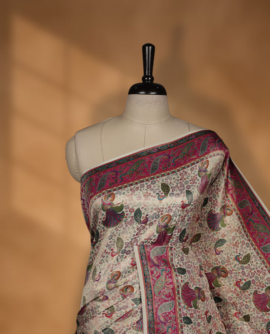 Ivory colour Pashmina silk saree richly woven with all over multicolour dancing figurines and paisley motifs, highlighted by a vibrant pink & green zari border and grand panelled pallu, paired with a matching woven border blouse piece.