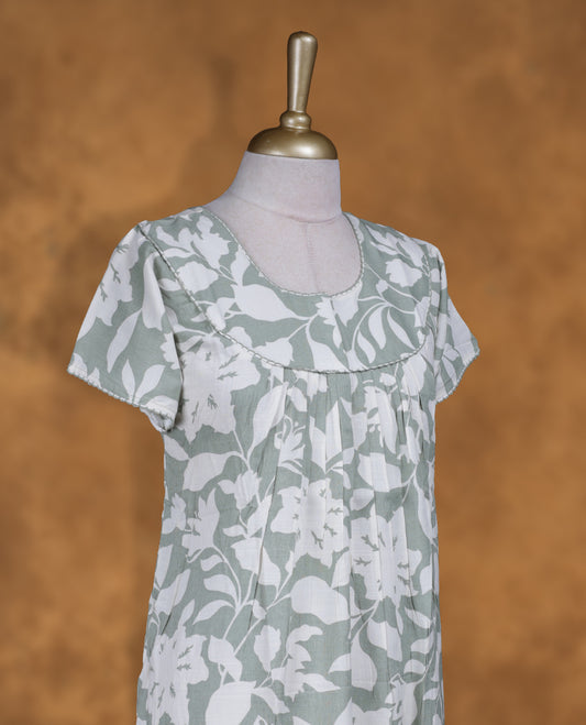 Dark sea green colour NStyle nighty featuring Offwhite Leaf patterns, a Round neckline and thread border, short sleeves, and a full ankle-length design.