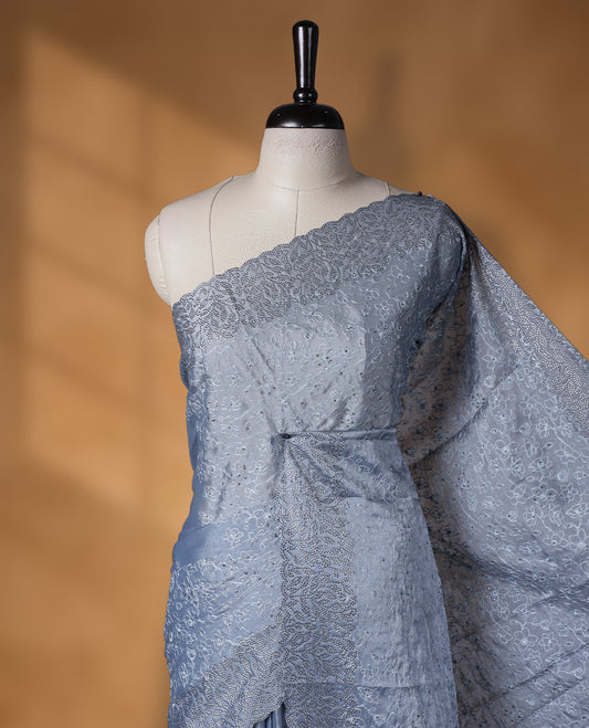 Ash blue colour velvet chiffon designer saree, featuring self colour thread embroidery kodi work on body, stone work and all over motifs on border and  pallu, Paired with matching blouse.