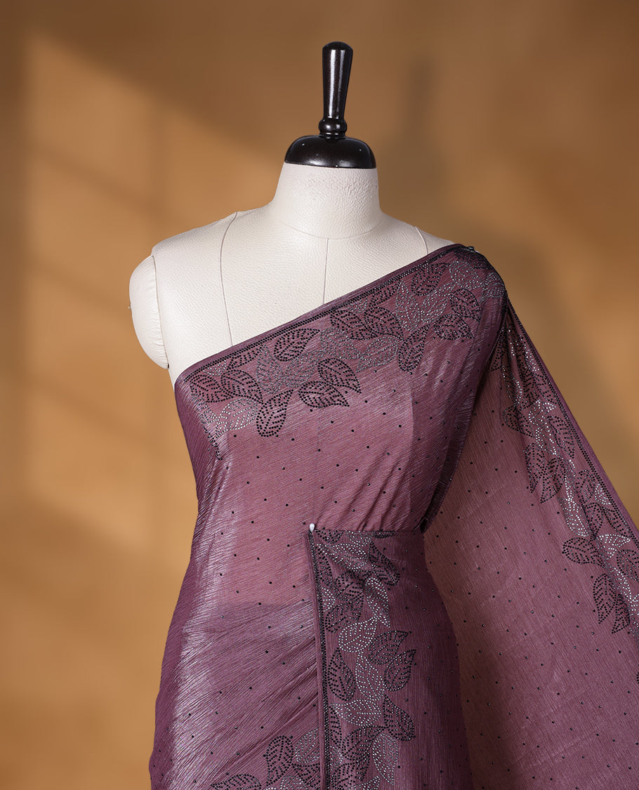 Grape colour chiffon designer saree, featuring black and white scattered stone on body, stone work and heavy stone leaf pattern on border and  pallu, Paired with matching blouse.