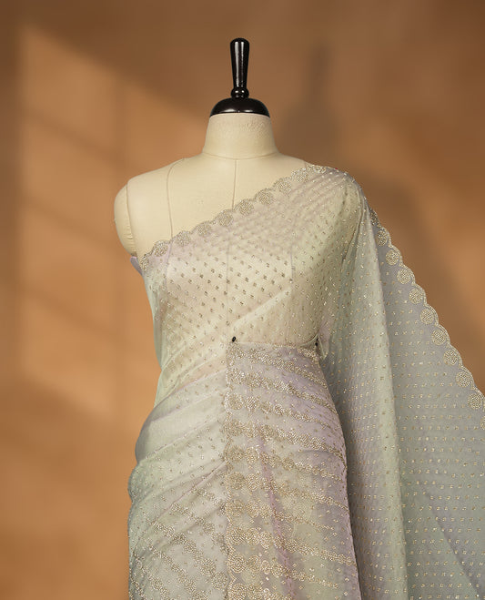 Gray and pink double shade Colour net shimmer fancy saree adorned with scattered white stone buttas all over the body, paired with a delicate stone worked border and matching blouse