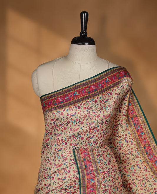 Beige colour Pashmina silk saree intricately woven with all over multicolour floral and paisley vines, accented by a rich pink and green zari border with bird motifs and a coordinated grand pallu, paired with a contrasting matching blouse piece.