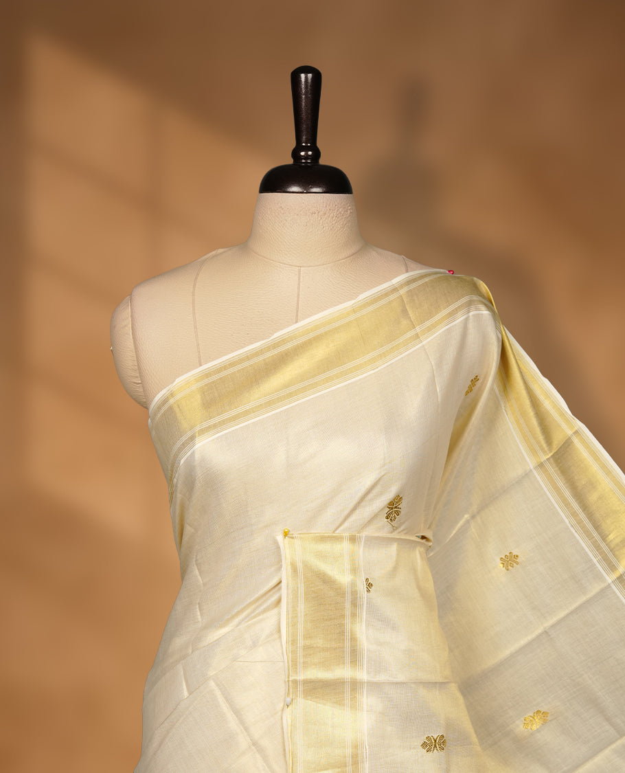 Elegant Light gold colour tissue Kerala saree with gold zari buttas, broad kasavu border, and richly woven traditional pallu, paired with a matching blouse