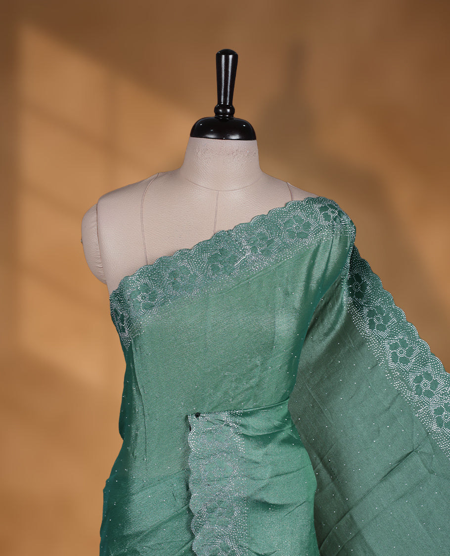 Pastel green colour shimmer designer saree, featuring white scattered stone on body, stone work and heavy stone floral pattern on border and  pallu, Paired with matching blouse.