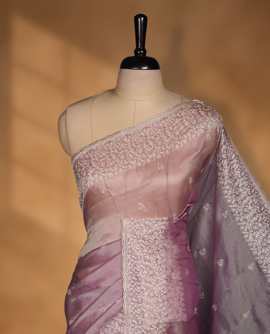 Pastel Lavender colour net organza saree featuring white thread embroidery motifs on body and  thread detailing on the border and paired matching blouse.