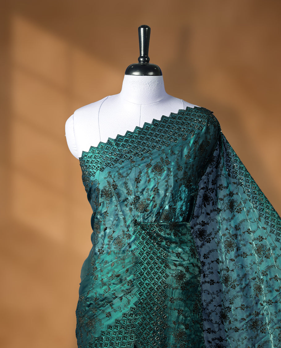 Dark pine green colour velvet chiffon designer saree, featuring black thread embroidery kodi pattern on body, black cut stone work and heavy stone border, pallu and Paired with matching blouse.