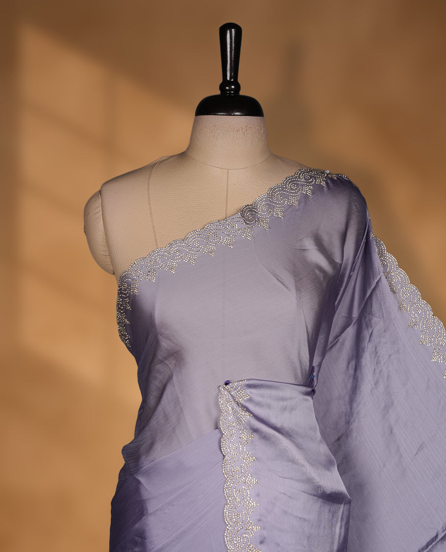 Lavender Colour Chiffon Designer Saree featuring Delicate White Stone motifs on Body, with Stone Detailing on the Border and Pallu, paired with a Matching Blouse.