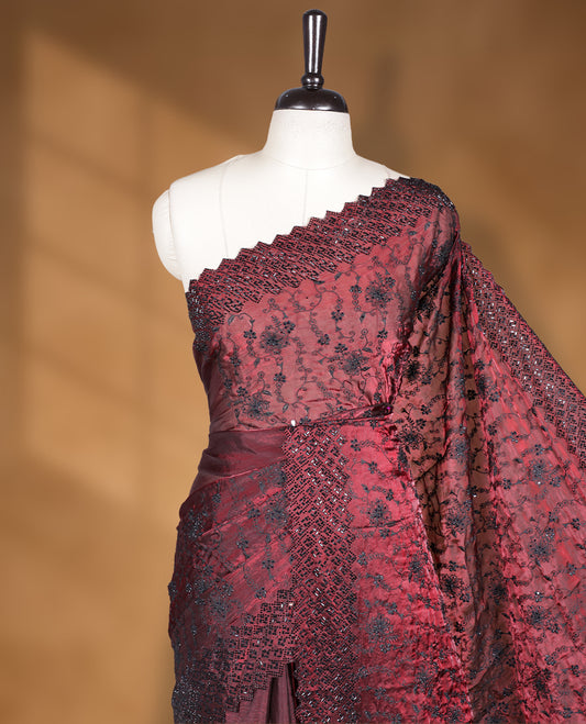 Maroon colour velvet chiffon designer saree, featuring black thread embroidery kodi pattern on body, black cut stone work and heavy stone border, pallu and Paired with matching blouse.