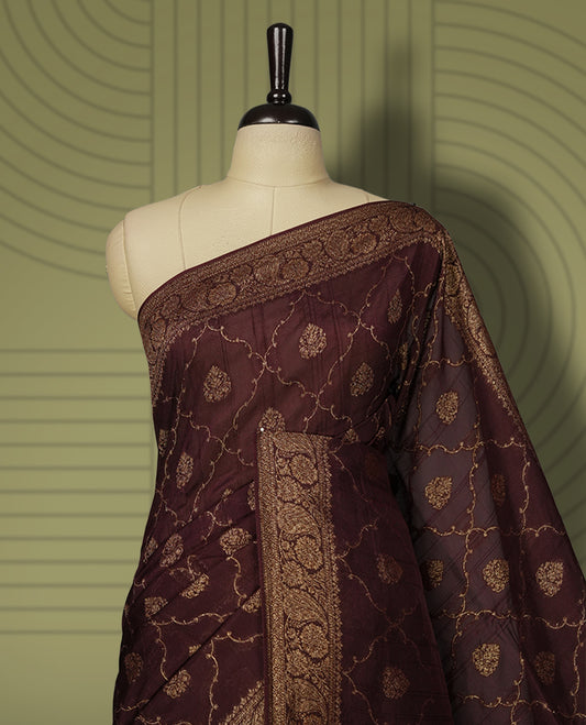 Coffee brown colour semi Banarasi Tussar Georgette saree with gold zari motifs on the body, a grand woven golden pallu, and ornate zari border. Includes a matching blouse piece for a complete look.
