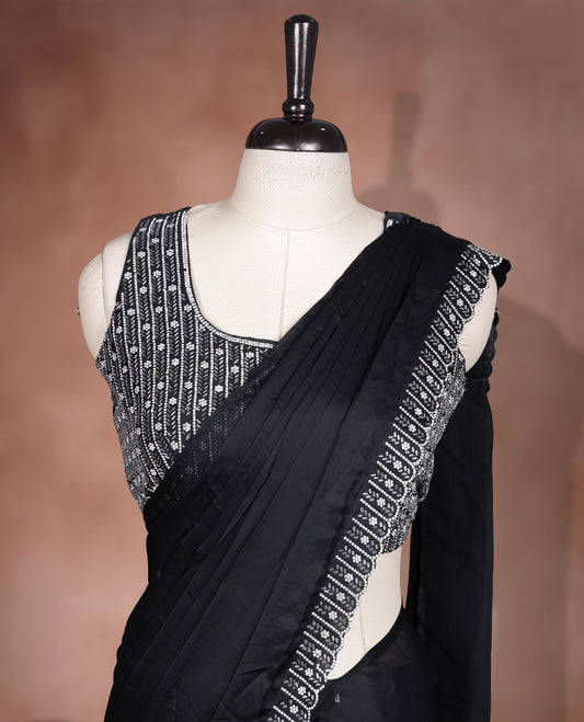 Elegant Black colour ready to wear saree adorned with rich silver stone and bead embroidery along the border and pallu, paired with a heavily embellished matching blouse for a grand festive look.