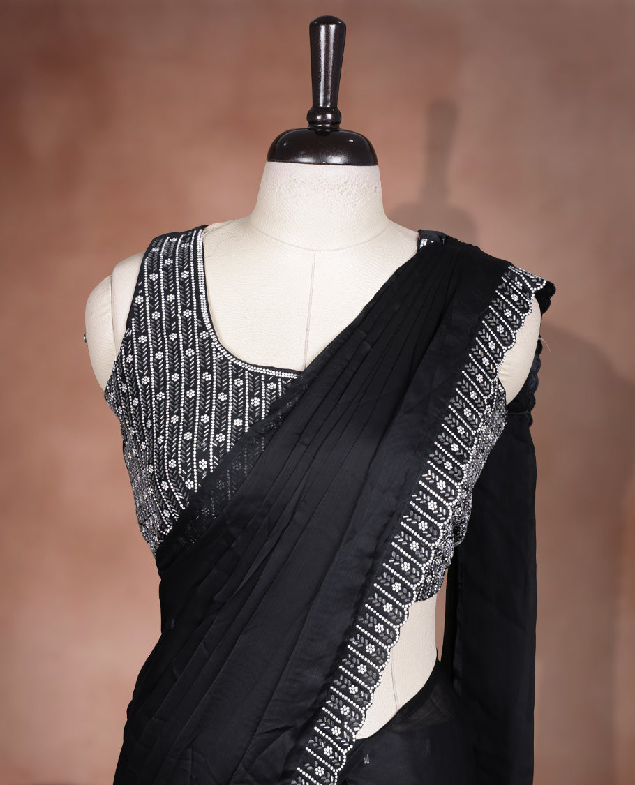 Elegant Black colour ready to wear saree adorned with rich silver stone and bead embroidery along the border and pallu, paired with a heavily embellished matching blouse for a grand festive look.