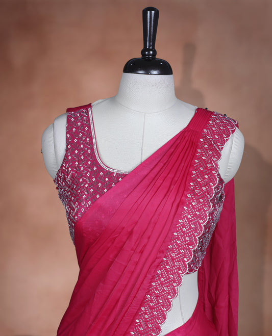Elegant Rani pink Colour ready to wear saree adorned with rich silver stone and bead embroidery along the border and pallu, paired with a heavily embellished matching blouse for a grand festive look.