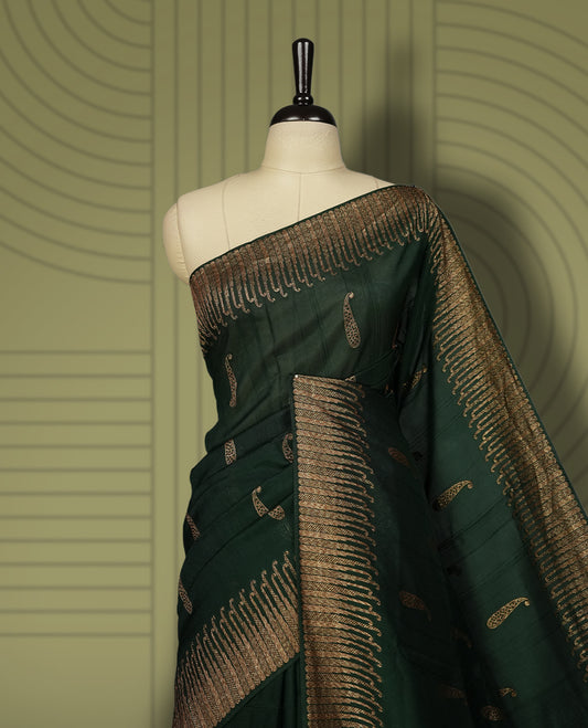 Dark green colour semi Banarasi Tussar Georgette saree with delicate gold zari buttas on the body, a rich golden zari pallu, and detailed woven border & Comes with a matching blouse piece.