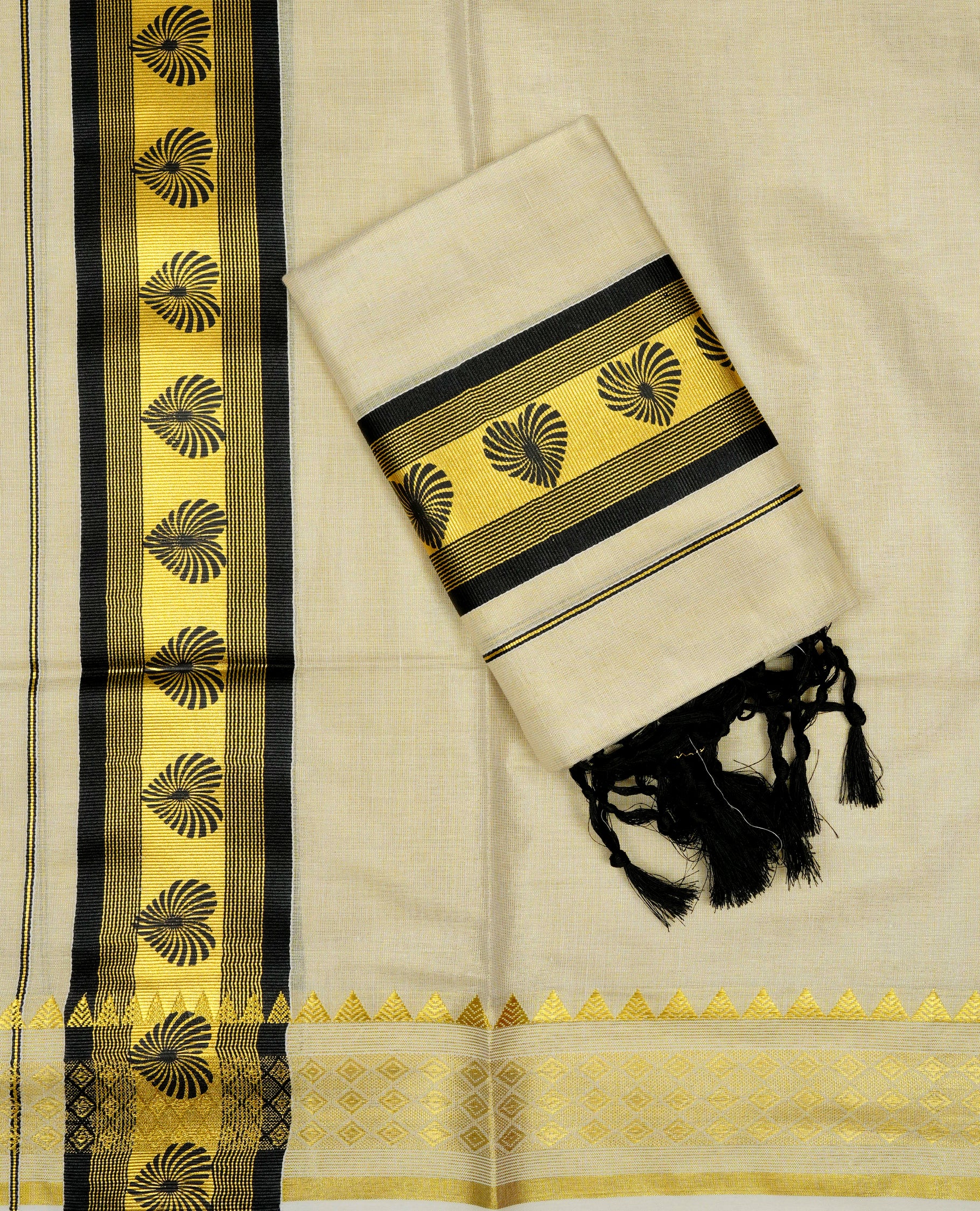 Light gold Tissue Set mundu featuring black heart print on gold kasav kara.