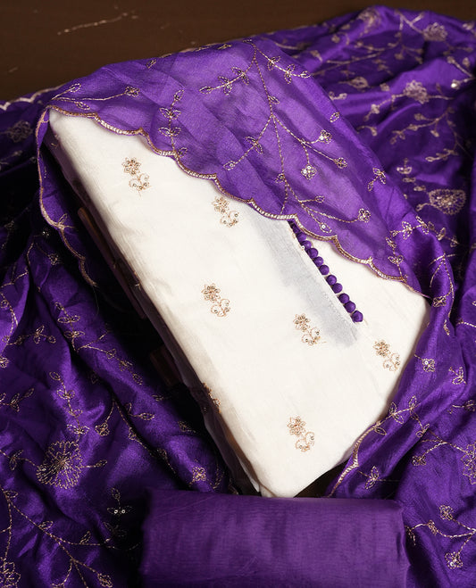 White colour churidhar material featuring thread embroidery on the front panel, contrast Violet colour dupatta with elegant border, and matching plain bottom
