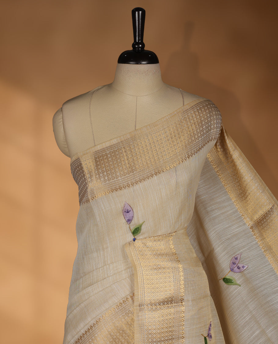 Beige colour Banarasi linen silk saree featuring hand brushed colour with Floral  & birds printed pattern on body, gold zari woven geometric design border with self colour pallu and comes with a matching blouse