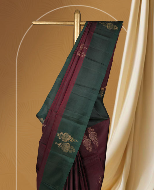 Dark brown colour  soft silk saree adorned with zari motifs, beautifully contrasted with a deep green border and pallu & Paired with a matching blouse.