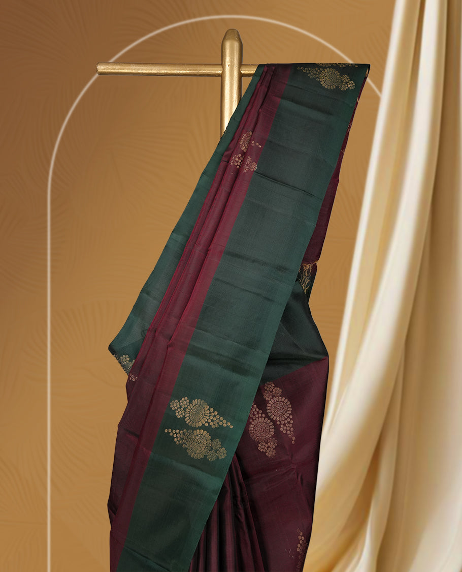 Dark brown colour  soft silk saree adorned with zari motifs, beautifully contrasted with a deep green border and pallu & Paired with a matching blouse.