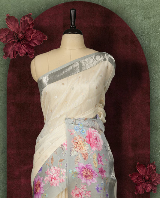 Ivory colour Kotta Tussar Silk saree features a vibrant digital floral print with small gold zari motifs on the body, and elegant blue colour banarasi border & Paired with a matching blouse,blending modern design with traditional elegance.