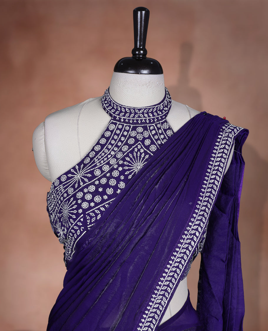 Elegant Dark purple colour ready to wear saree adorned with rich silver stone embroidery along the border and pallu, paired with a heavily embellished matching blouse for a grand festive look.