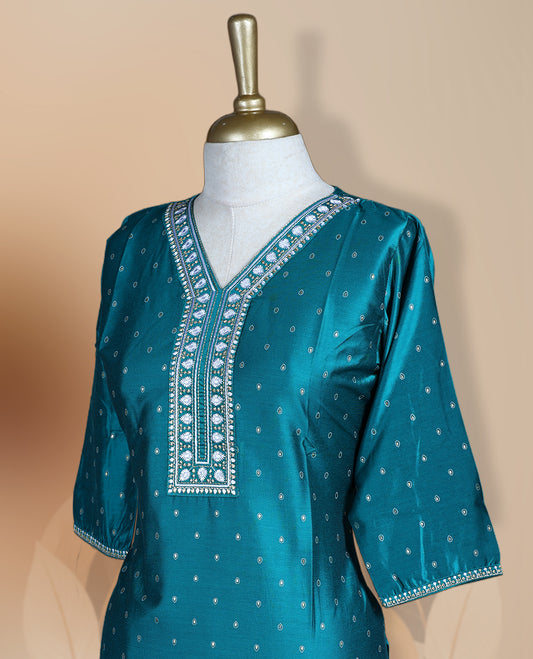 Peacock green colour kurti with delicate white embroidery and golden work on the neckline and sleeves, Features a stylish V-neck and 3/4th sleeves & ideal for casual outings or festive occasions.