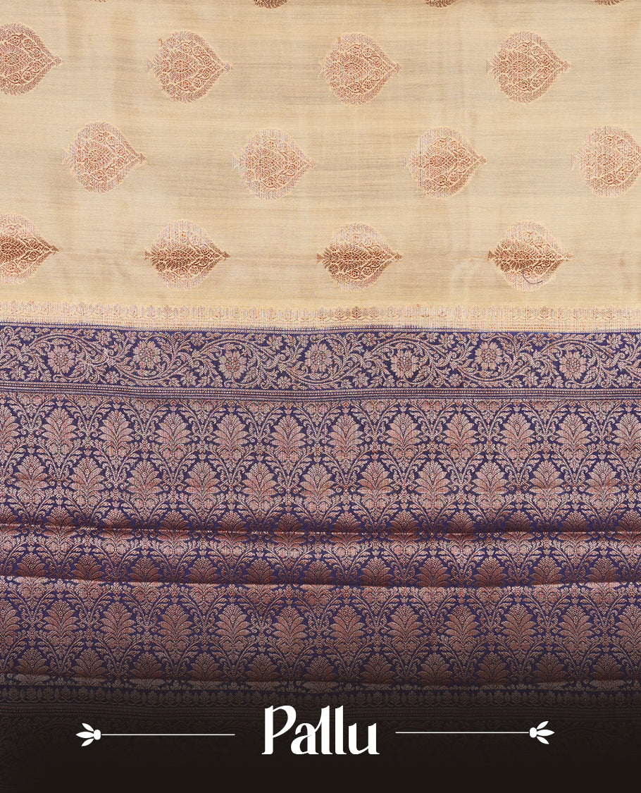 Cream beige Banaras soft silk saree with gold zari oval motifs on body, with contrast Blue colour floral pattern on pallu, border, and Matching blouse.