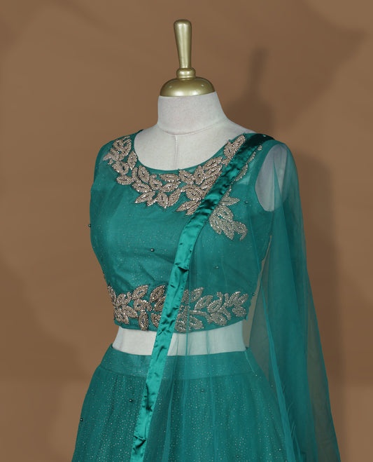 Teal green colour lehenga set with stitched sleeveless blouse featuring floral sequin embroidery on neckline and waist, paired with a matching shimmer layered flared lehenga and sheer dupatta