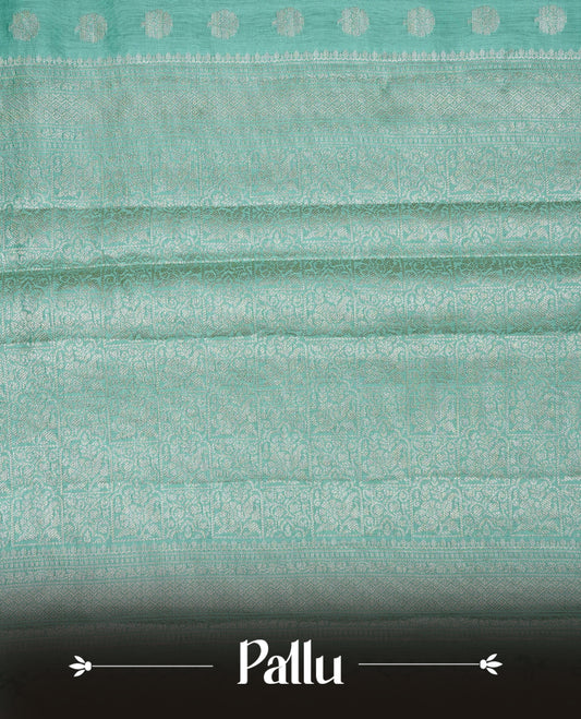 Light green colour banaras saree featuring silver zari buttas on body, complemented silver zari on self colour border, comes with matching blouse piece.