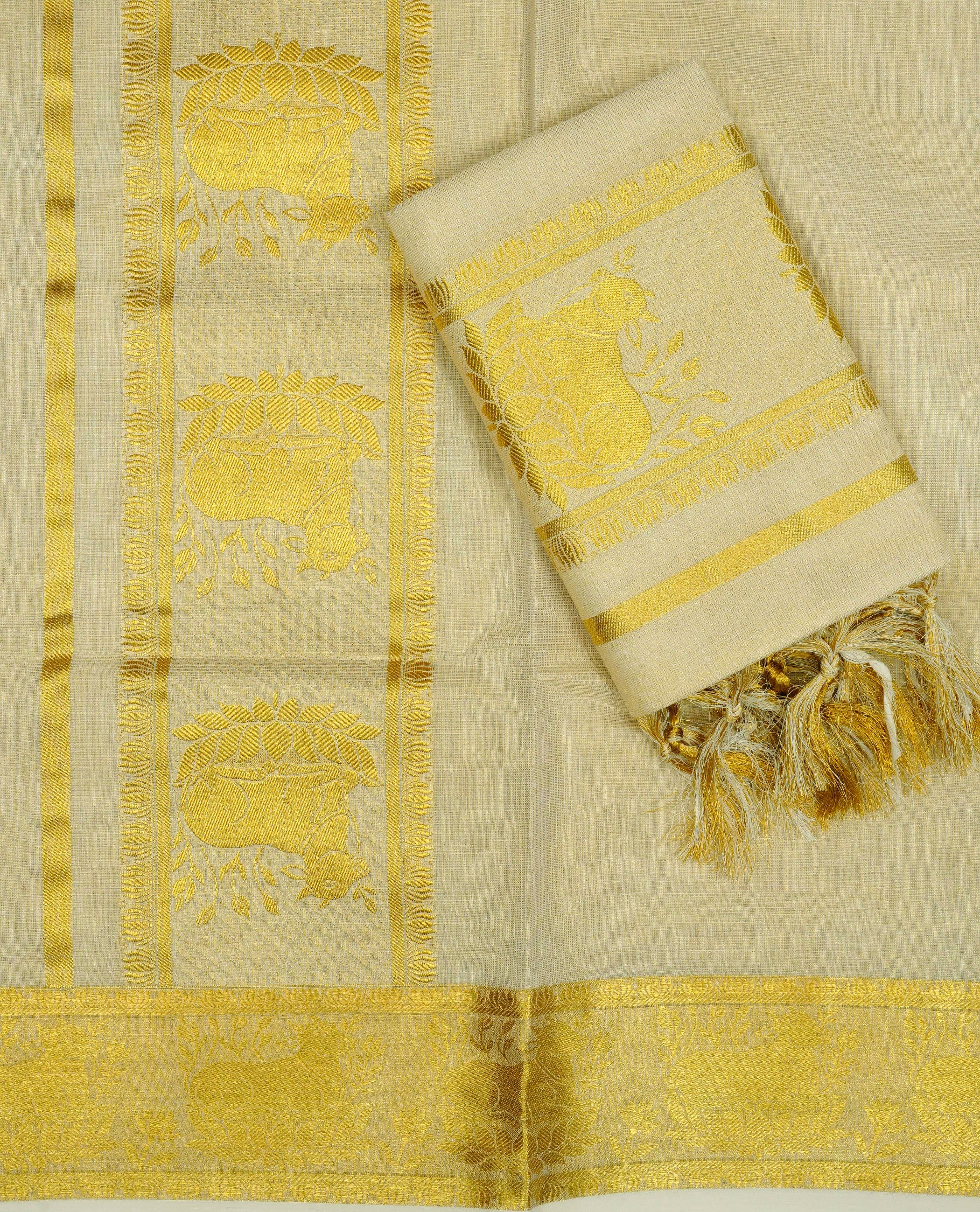 Cream Colour tissue set mundu featuring a plain body, enhanced with elegant Cow Design on the gold zari kara.