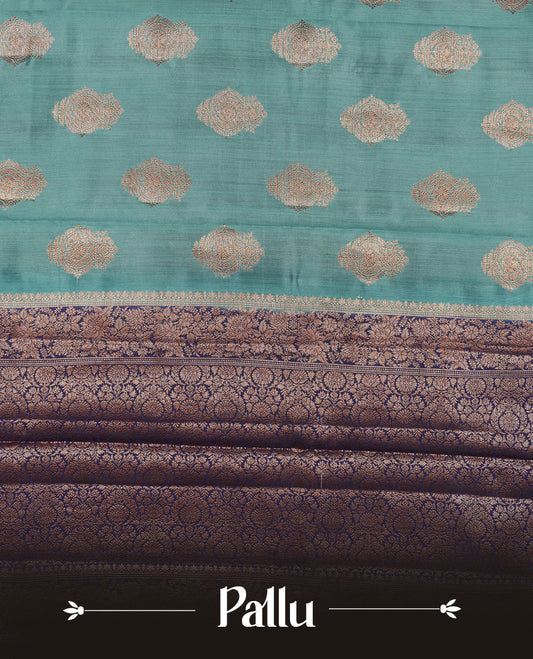 Aqua blue Banaras soft silk saree with gold zari motifs on body, with contrast Dark blue colour floral pattern on pallu, border, and Matching blouse.