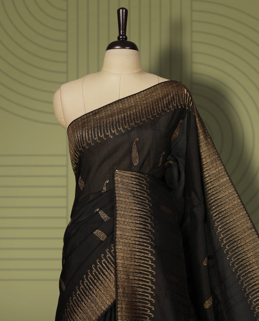 Black colour semi Banarasi Tussar Georgette saree with delicate gold zari buttas on the body, a rich golden zari pallu, and detailed woven border & Comes with a matching blouse piece.
