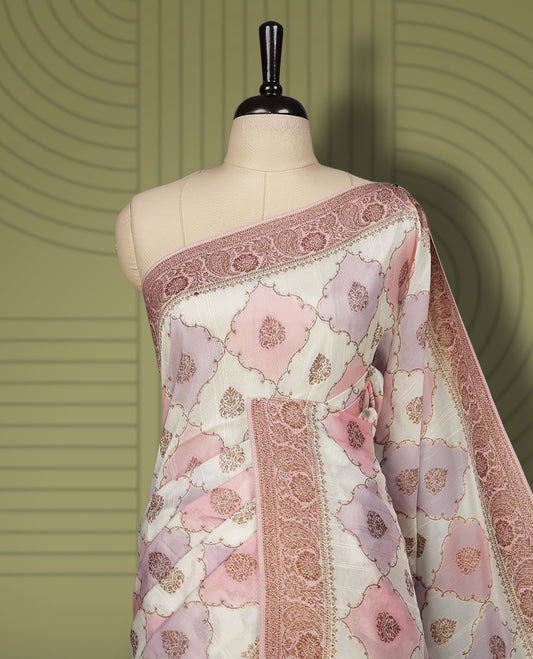 Pastel cream colour semi Banarasi Tussar Georgette saree with blush pink and lilac zari floral motifs, ornate dusty rose border and rich pallu & Includes a matching unstitched blouse piece to complete the look.