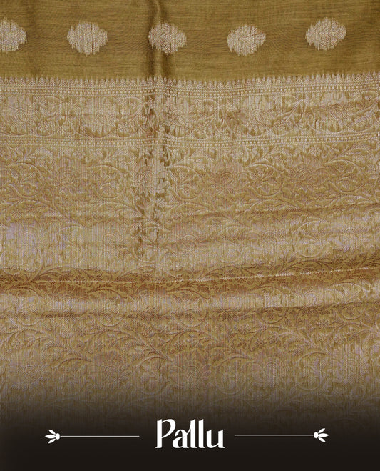 Olive colour Banaras silk saree featuring gold zari buttas on body, complemented by self colour with zari border, comes with matching blouse piece.