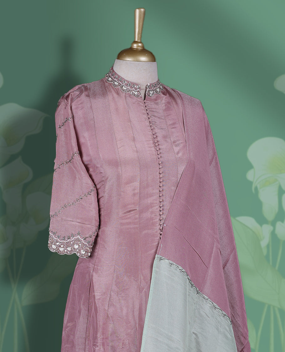 Onion pink colour Anarkali Suit featuring cut bead, pearl, and sequin work on the neckline and sleeves & Paired with a soft tri tone dupatta with plain bottom, perfect for festive and formal occasions.