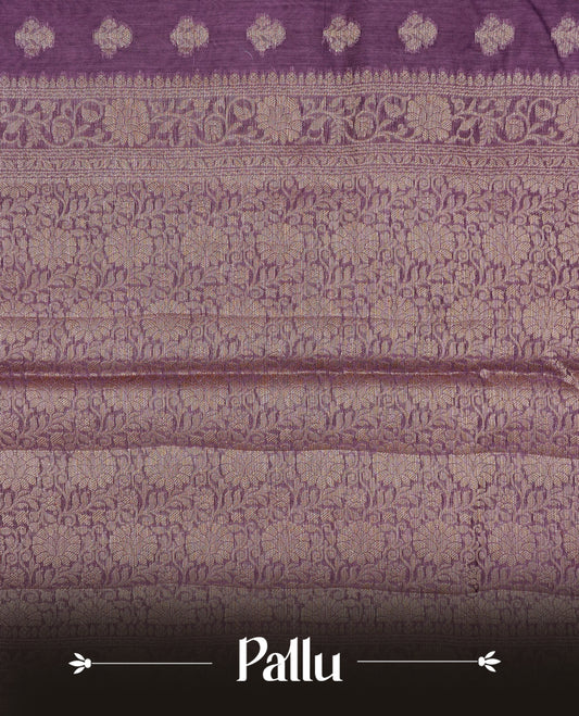 Wine colour Banaras silk saree featuring gold zari buttas on body, complemented by self colour with zari border, comes with matching blouse piece.