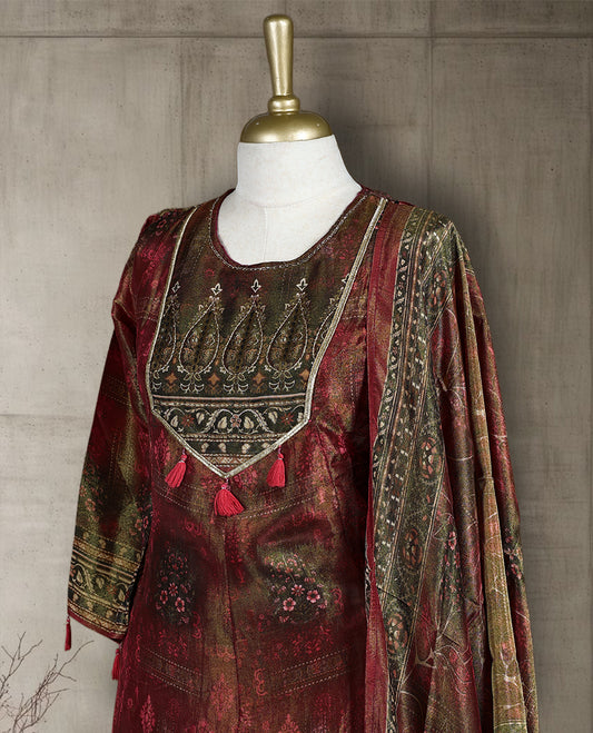 Maroon and olive green salwar from TWARA, featuring a round neck with intricate zari embroidery and tassel detailing, paired with a matching bottom and a richly woven dupatta showcasing traditional motifs.